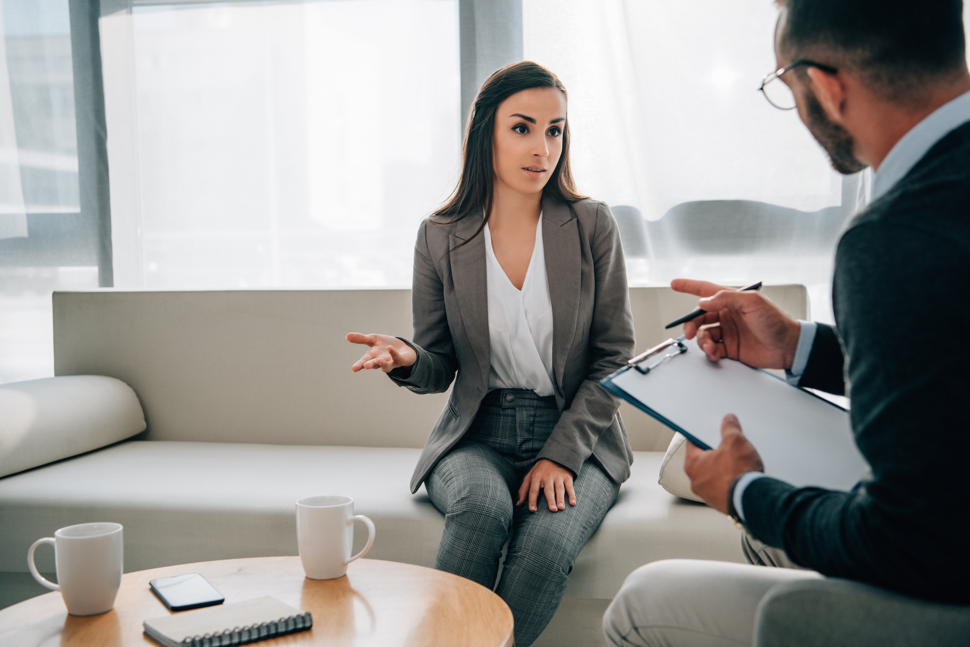 patient and psychologist talking in doctors office